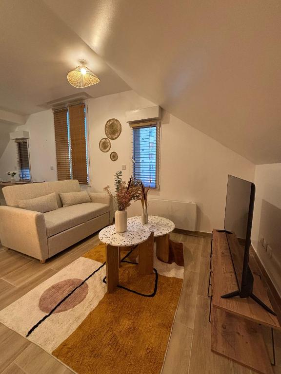 a living room with a couch and a table at Résidences Eska in Bobigny