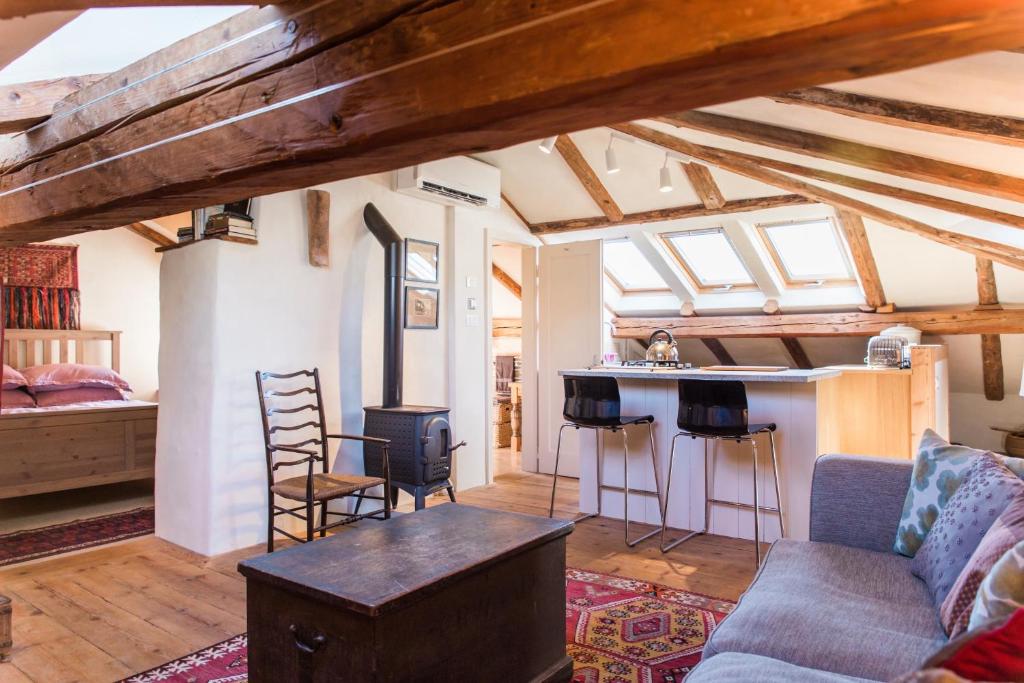 a living room with a couch and a bar in a room at Tolmin center apartments Townhouse & Loft in Tolmin