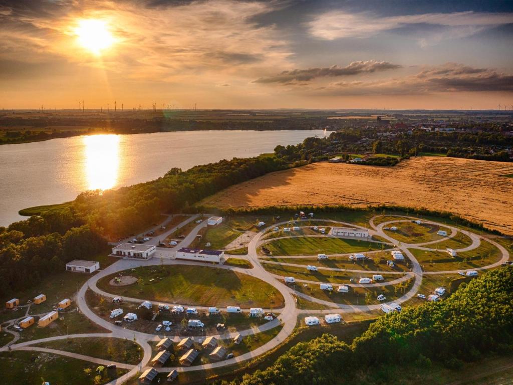 an aerial view of a parking lot next to a river at Sonnenkap Camping in Prenzlau