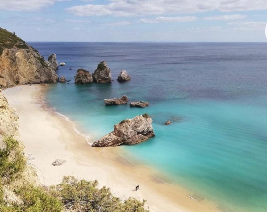 a view of a beach with rocks in the water at Sesimbra Horizon in Sesimbra