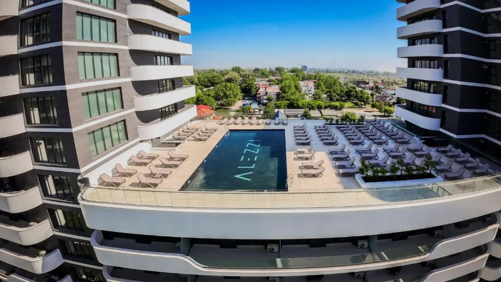 an aerial view of a building with a swimming pool at Eleven Odyssey Apartment in Năvodari