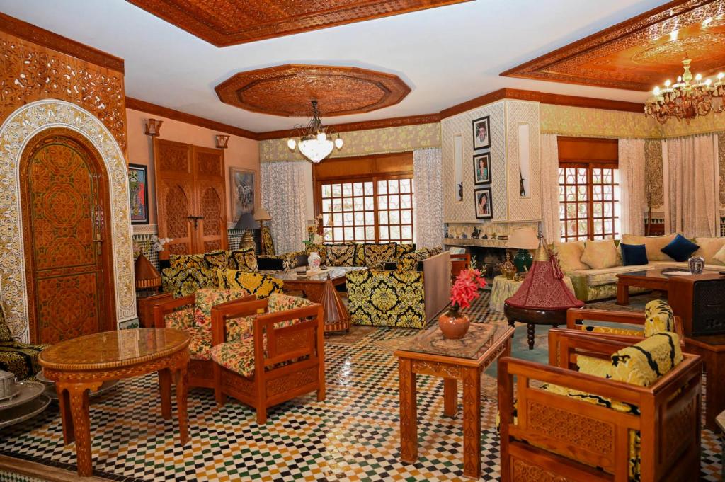 a large living room with wooden furniture in a room at Dar Maya Original Suite & Spa in Fez