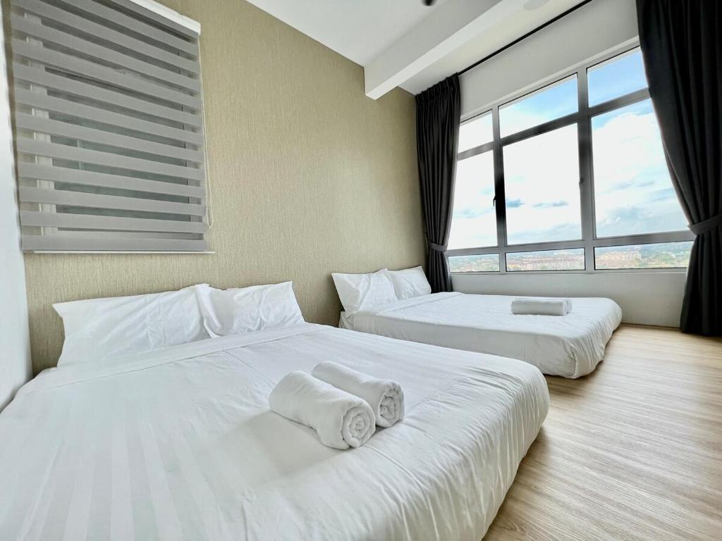two white beds in a room with large windows at Melaka Nova-8 Studio City-View-4pax in Malacca
