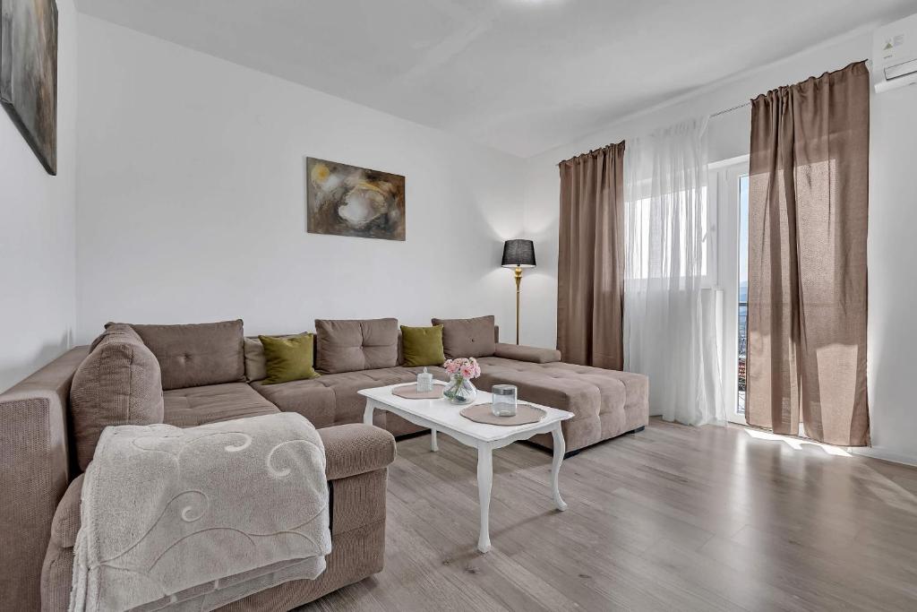 a living room with a couch and a table at Apartment Green Valley in Imotski
