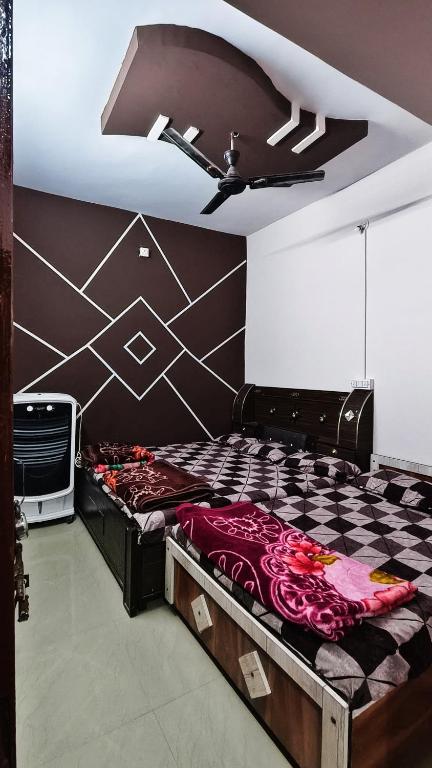 a bed in a room with a ceiling at Adiyogi Guest House in Ujjain