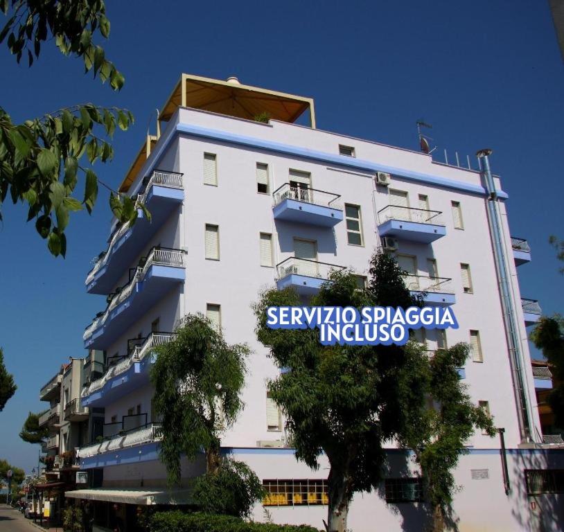 a large white building with a sign on it at Silvi Marina Sea Resort in Silvi Marina