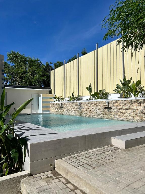 a swimming pool in front of a fence at The San Juan House in san juan la union