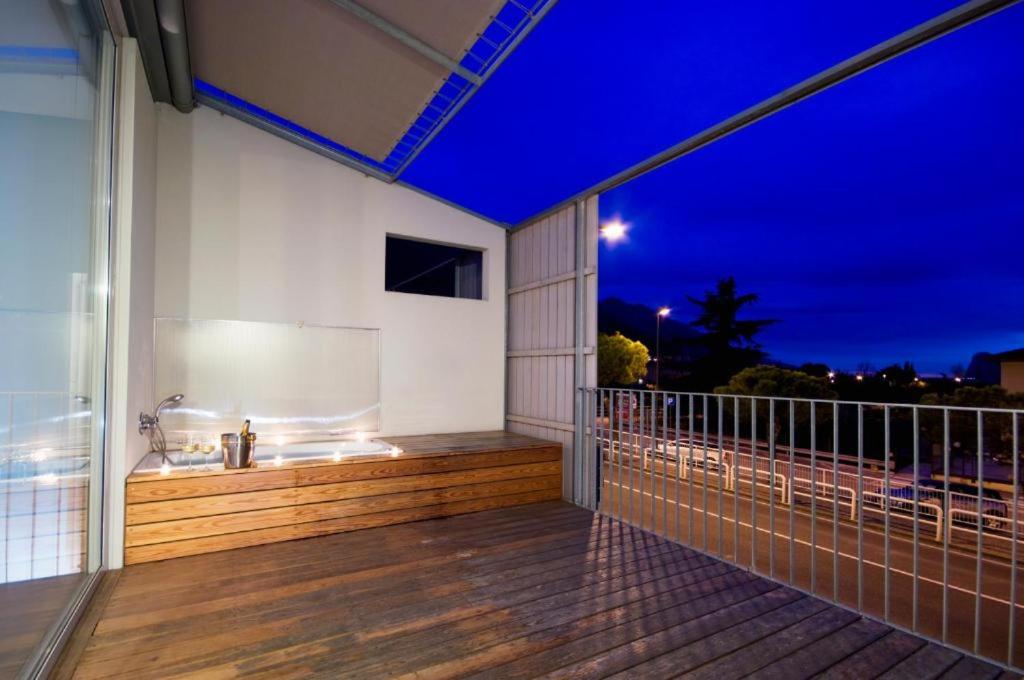 a balcony of a house with a bath tub at meckisapartment in Nago-Torbole