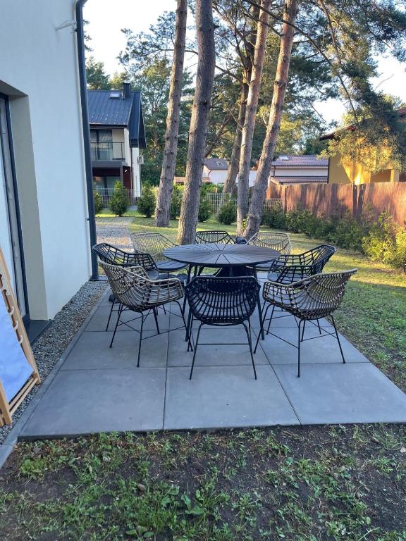 a table and chairs sitting on a patio at Baltic Park in Rozewie
