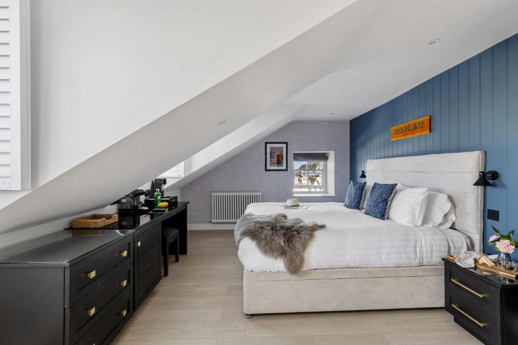 a bedroom with a bed with a dog sitting on it at Provident Suite - Free Wi-Fi - Sea View in Brixham