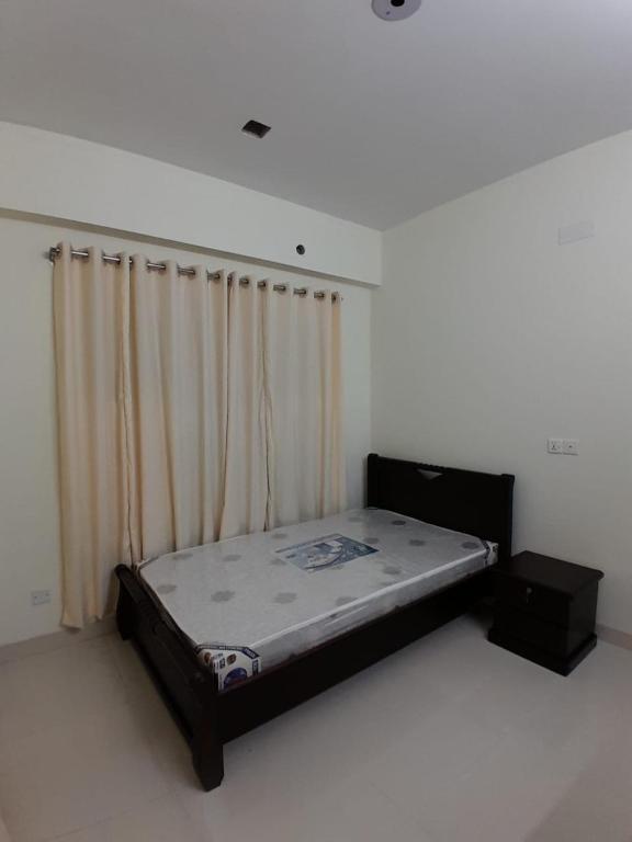 a bed in a room with a curtain at Chiakunja in Dhaka