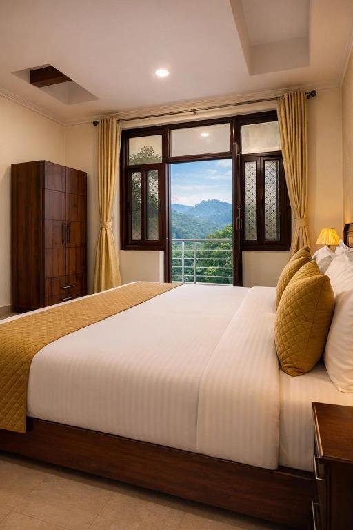 a bedroom with a large bed with a large window at Hotel Nirvana Palace Near Parmarth Niketan in Rishīkesh