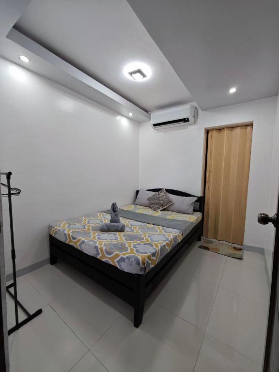 a bedroom with a bed in a room at Fab's Spot El Nido in El Nido
