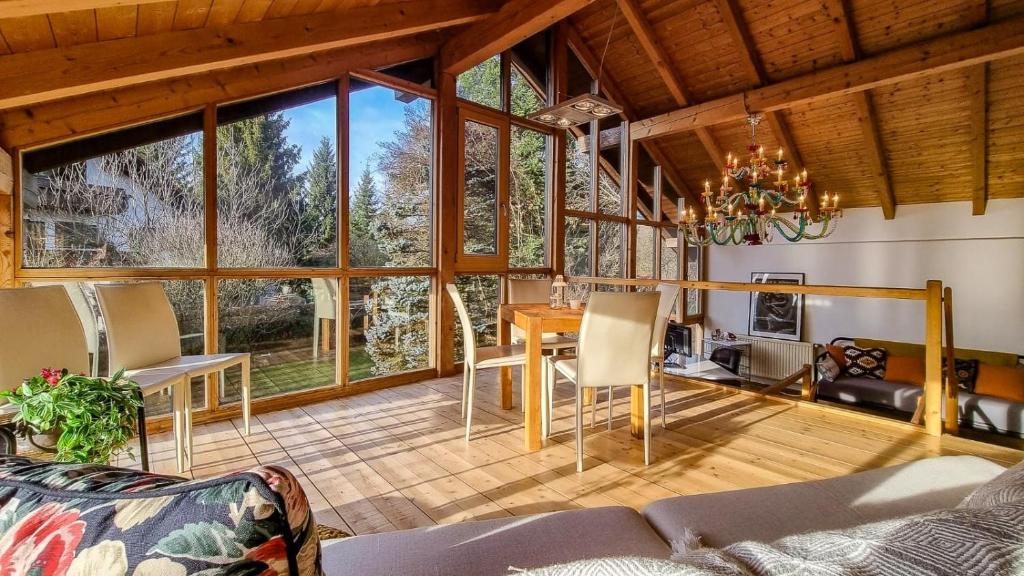 a living room with a table and chairs at Villa With Split-Level Architecture By Ammersee in Hechenwang