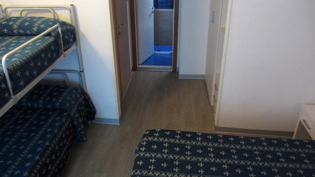Postel nebo postele na pokoji v ubytování Hotel Sorriso - molto più di una stella