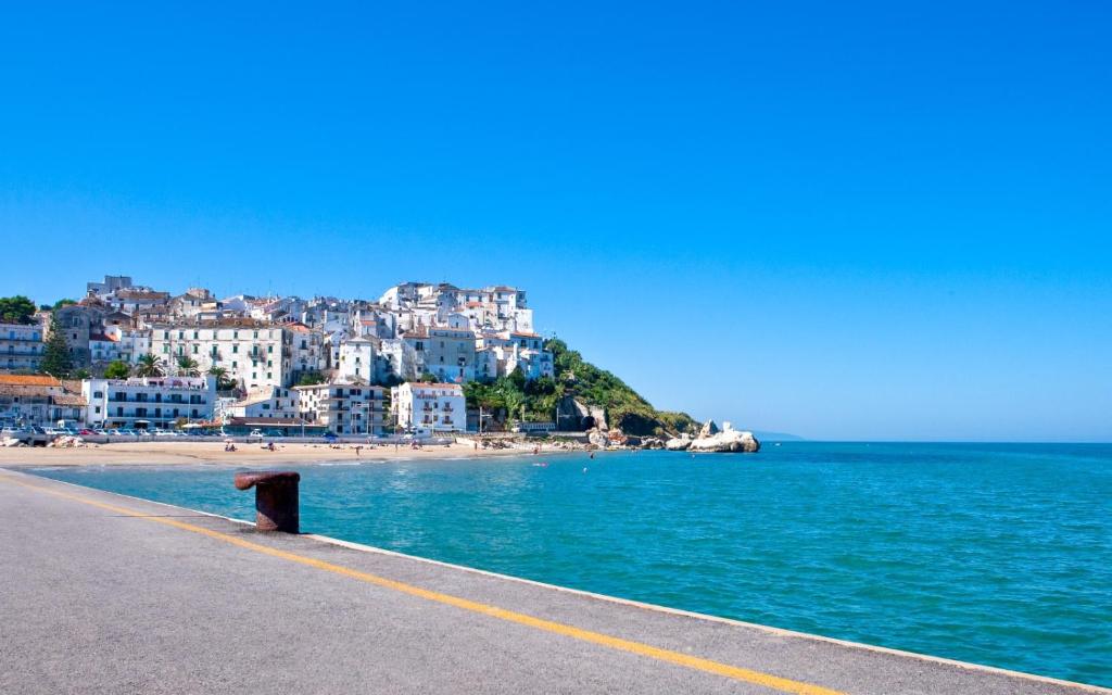 a view of a beach with buildings and the ocean at Hotel Rodi Beach FRONTE SPIAGGIA in Rodi Garganico