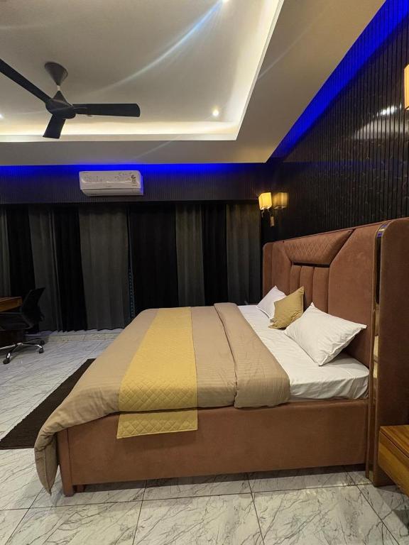 a bedroom with a bed with a ceiling fan at Hotel Namaste With Jacuzzi in Ghaziabad