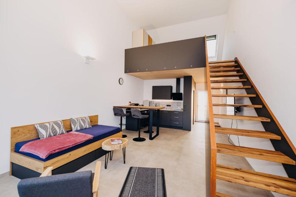 a room with a bed and a desk and a staircase at Mühlenhof Franken in Kirchheim