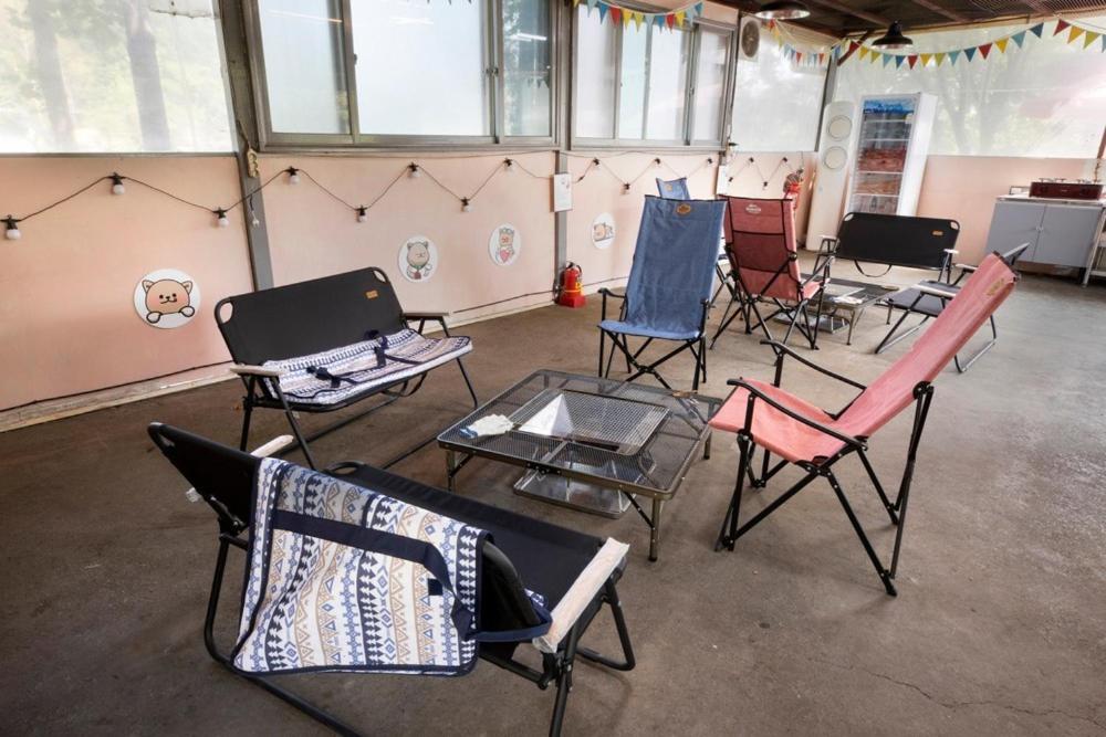 a group of chairs and tables in a room at Glamdog - Gapyeong in Gapyeong