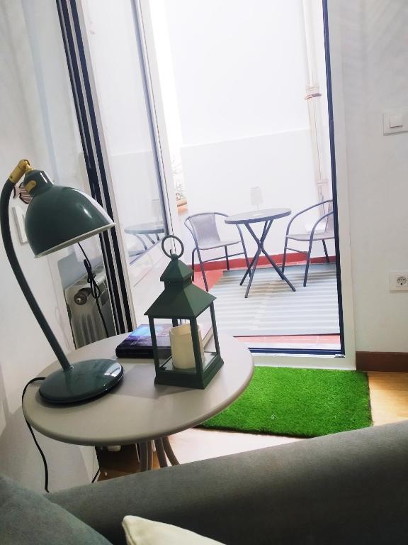 a lamp sitting on a table in a living room at La CASINA de HUGO con Terraza in Luanco