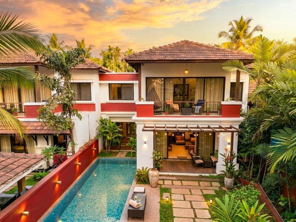 an image of a house with a swimming pool at StayVista at Villa Arcadia with Alfresco Dining in Candolim