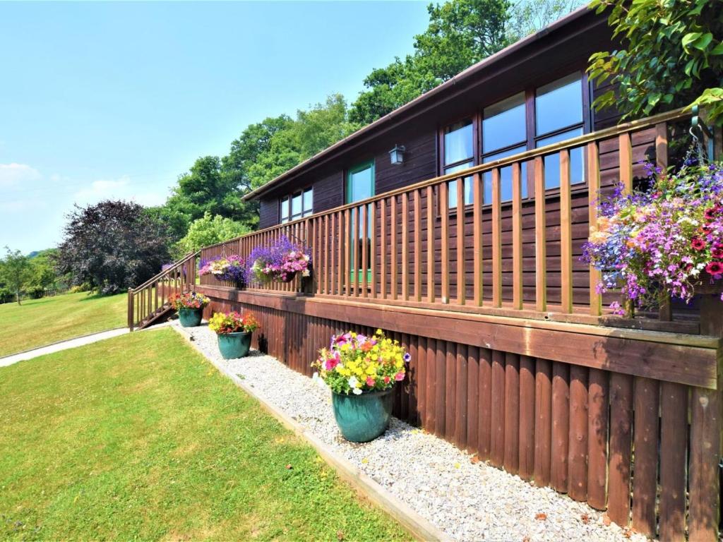 a fence with flowers in pots on it at 1 Bed in Liskeard oc-nutha in Warleggan