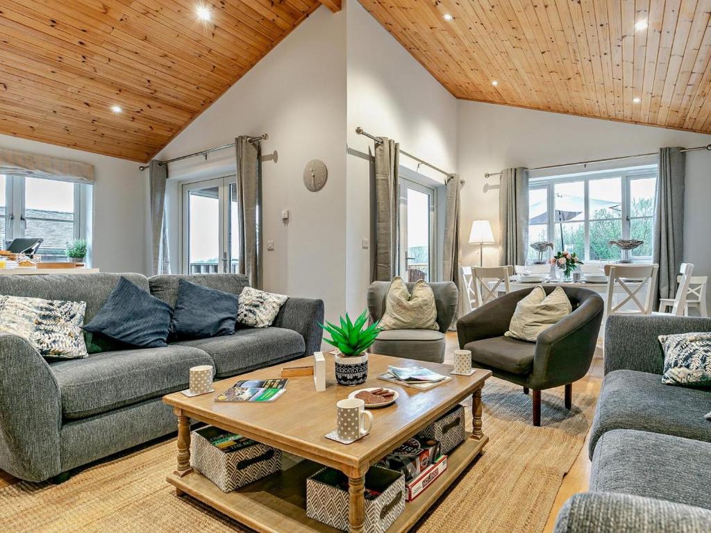 a living room with couches and a table at 3 Bed in St. Columb oc-43079 in Saint Columb Major