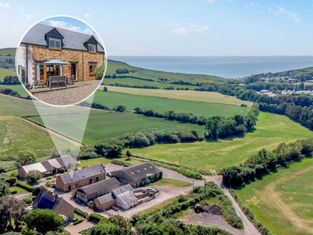 an aerial view of a house in the countryside at 3 Bed in Bridport oc-dc049 in Chideock