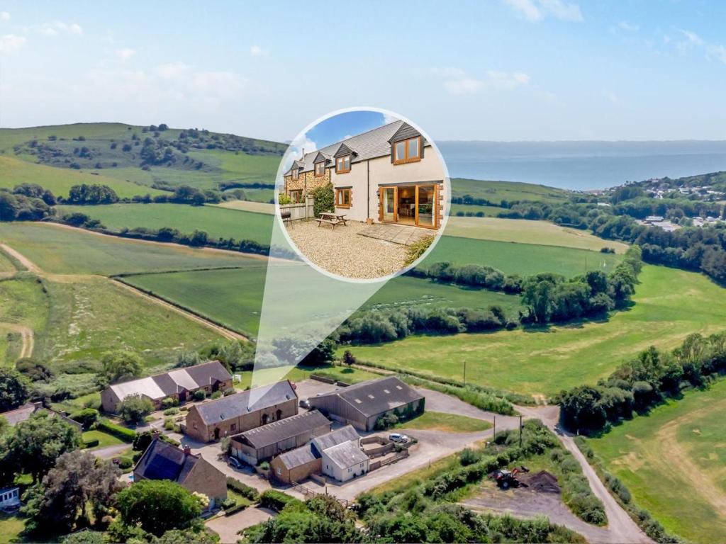 an aerial view of a house in the countryside at 3 Bed in Bridport oc-dc087 in Chideock