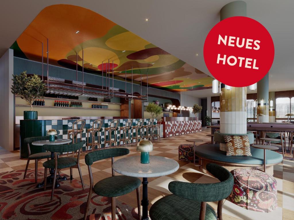 a hotel lobby with tables and chairs and a sign that reads nerves hotel at Scandic Charlottenburg in Berlin