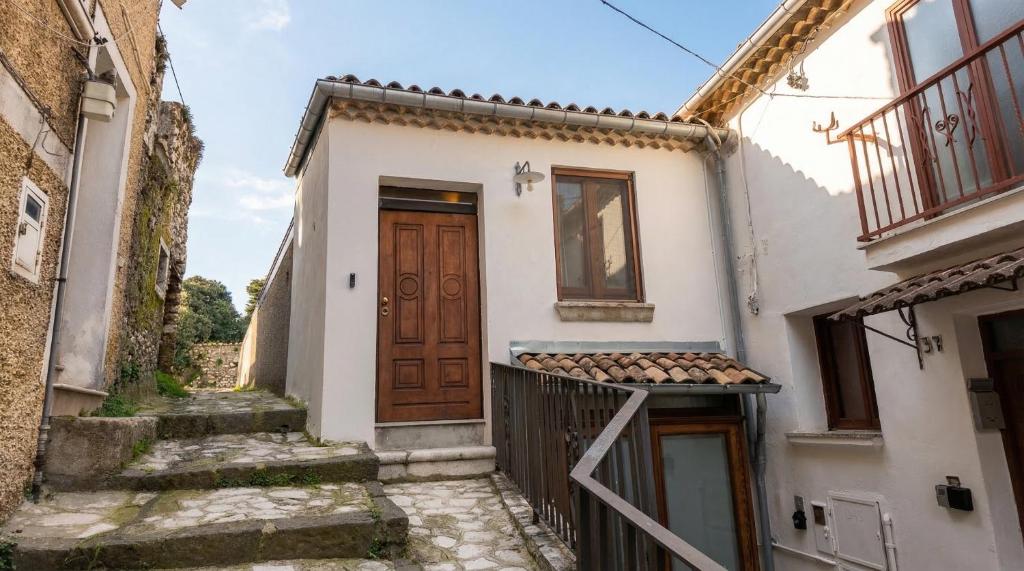 a house with a wooden door on a street at Casa Ereva in Bagnoli Irpino