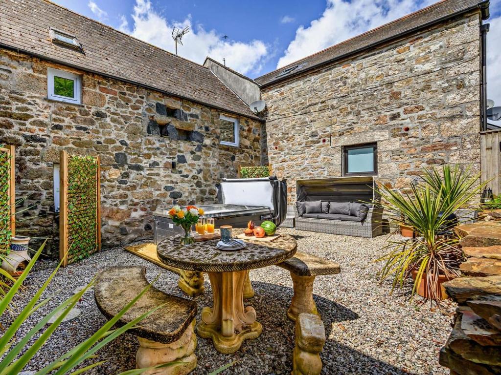 a patio with a table in front of a brick building at 2 Bed in Bodmin oc-90216 in Bodmin