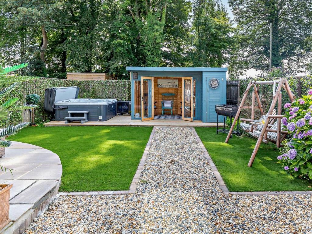 a garden with a playground and a shed at 4 Bed in Bodmin oc-90215 in Bodmin