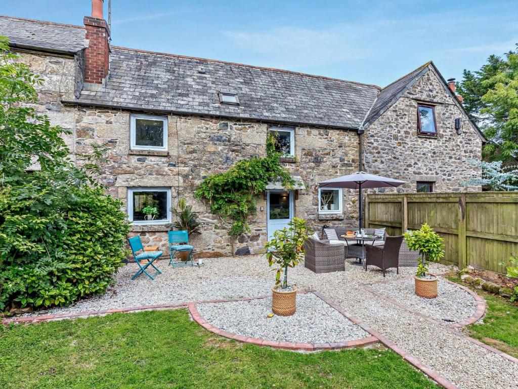 an exterior view of a stone house with a patio at 3 Bed in Bodmin oc-90217 in Bodmin
