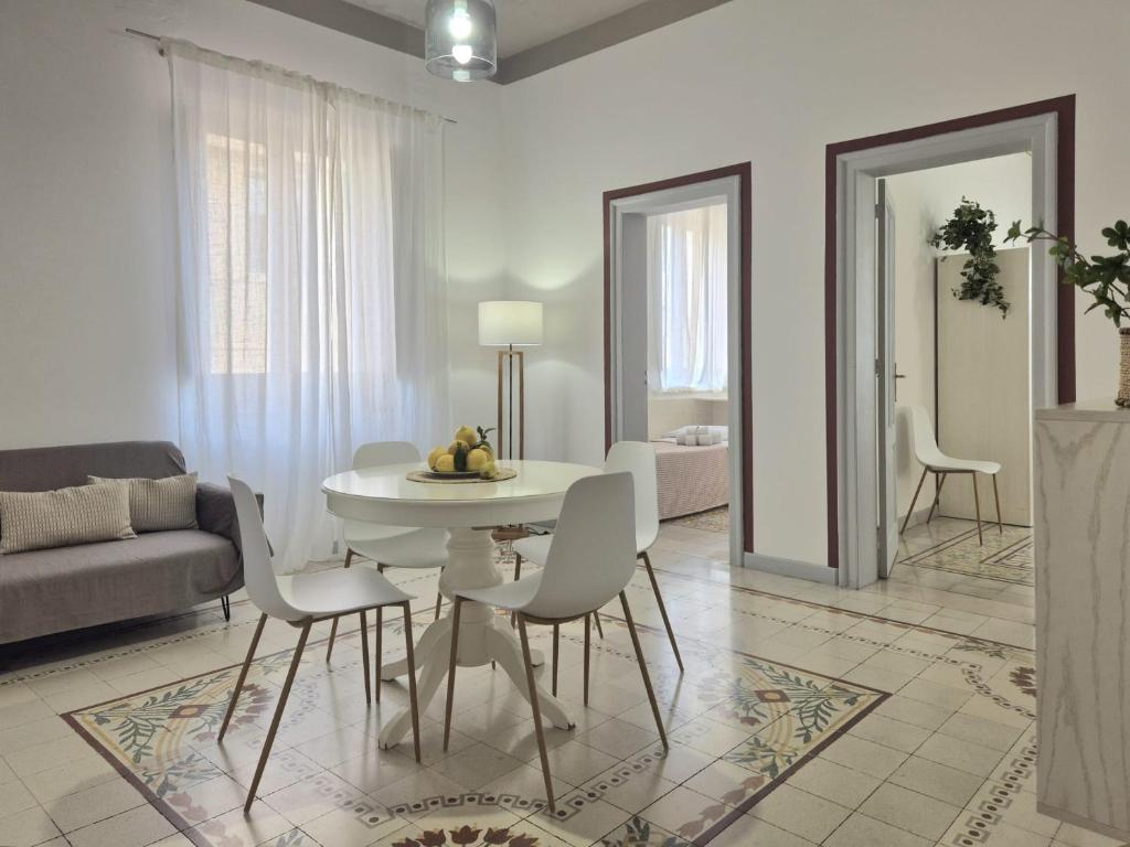 a living room with a table and chairs and a couch at La Mattanza in Trapani