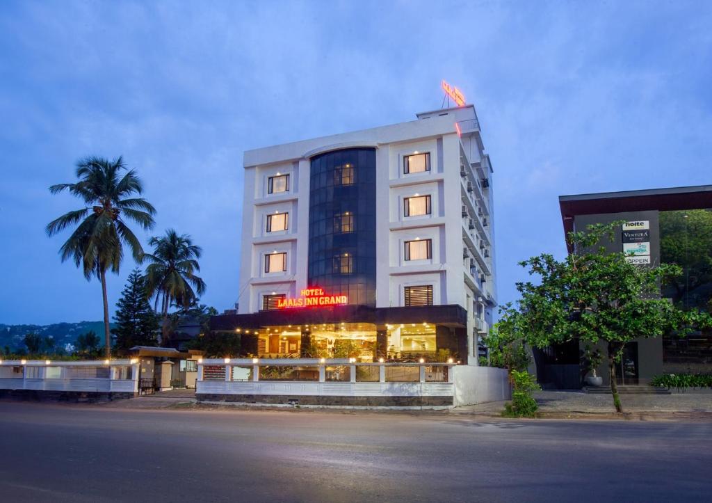 a hotel building with lights on the front of it at Hotel Laals Inn Grand in Cochin