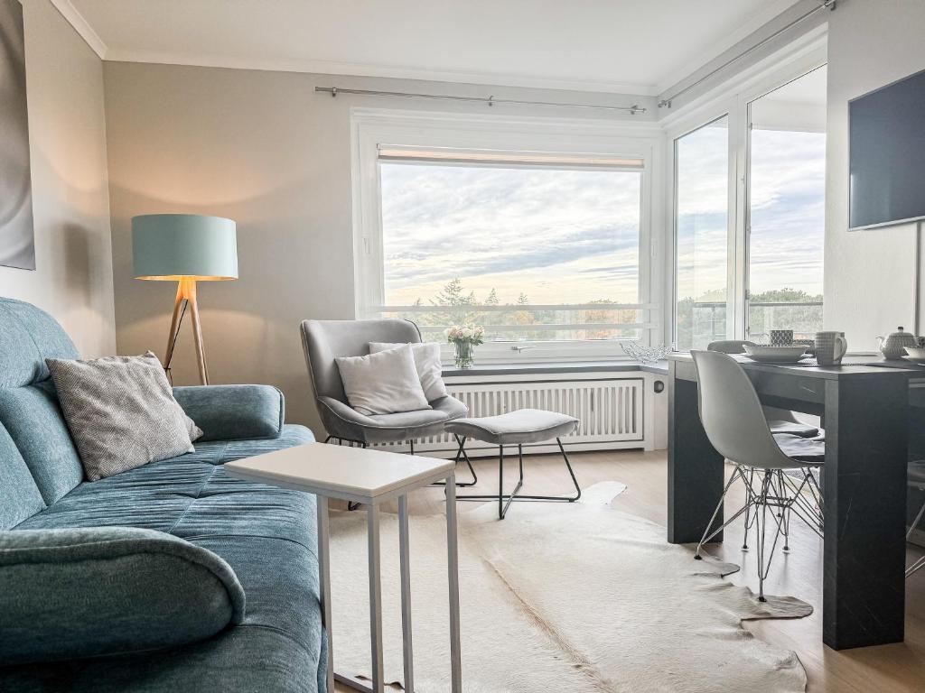 a living room with a couch and a table at Carpe Diem 203 in Niendorf