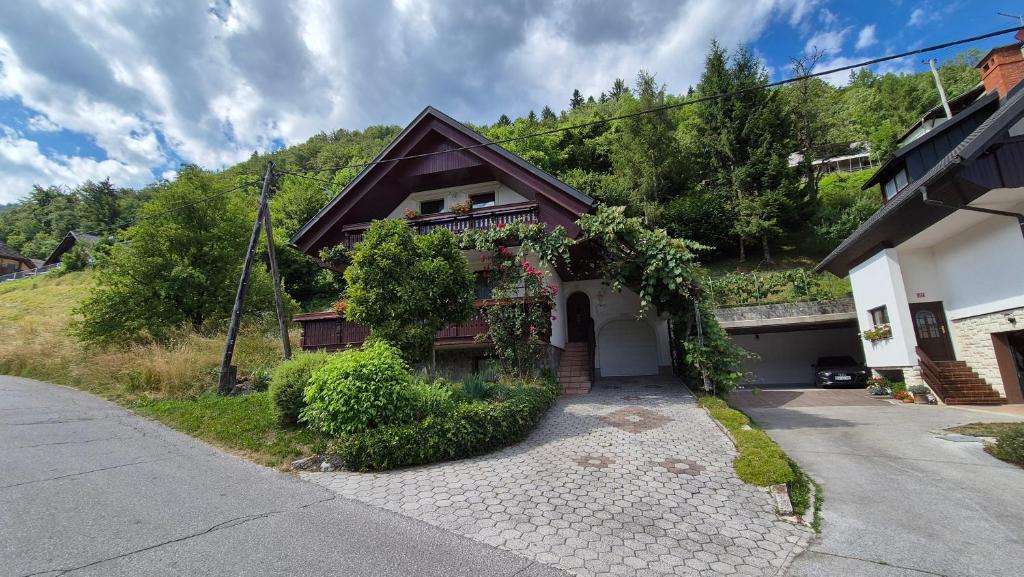 a house with a ivy growing on the side of it at Počitniška hiša Novak in Bohinj