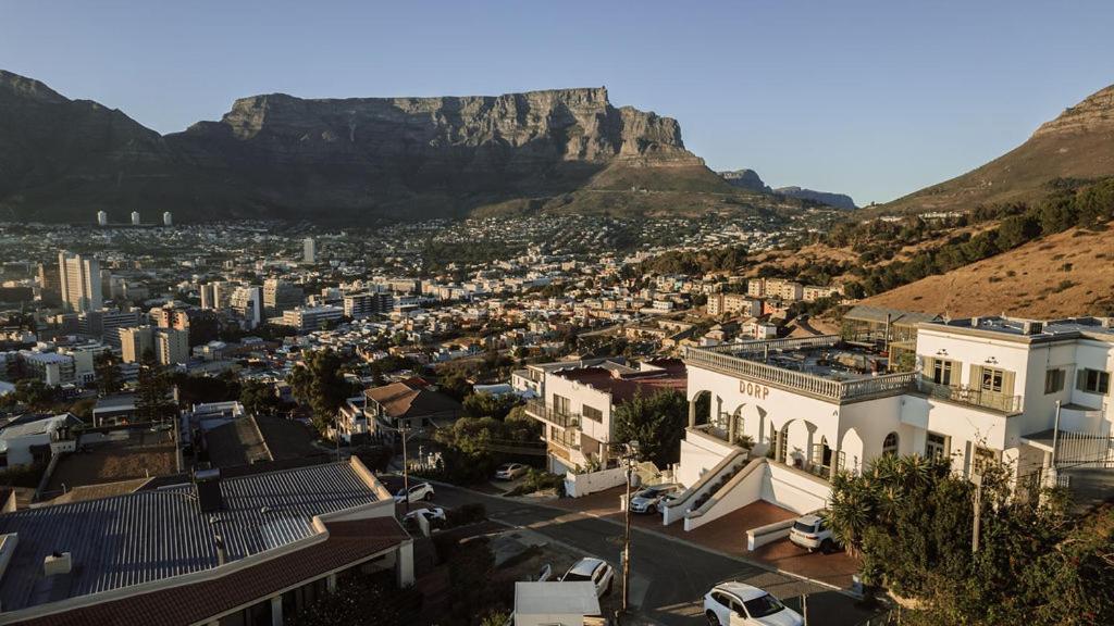 a city with the table mountain in the background at Dorp Hotel in Cape Town