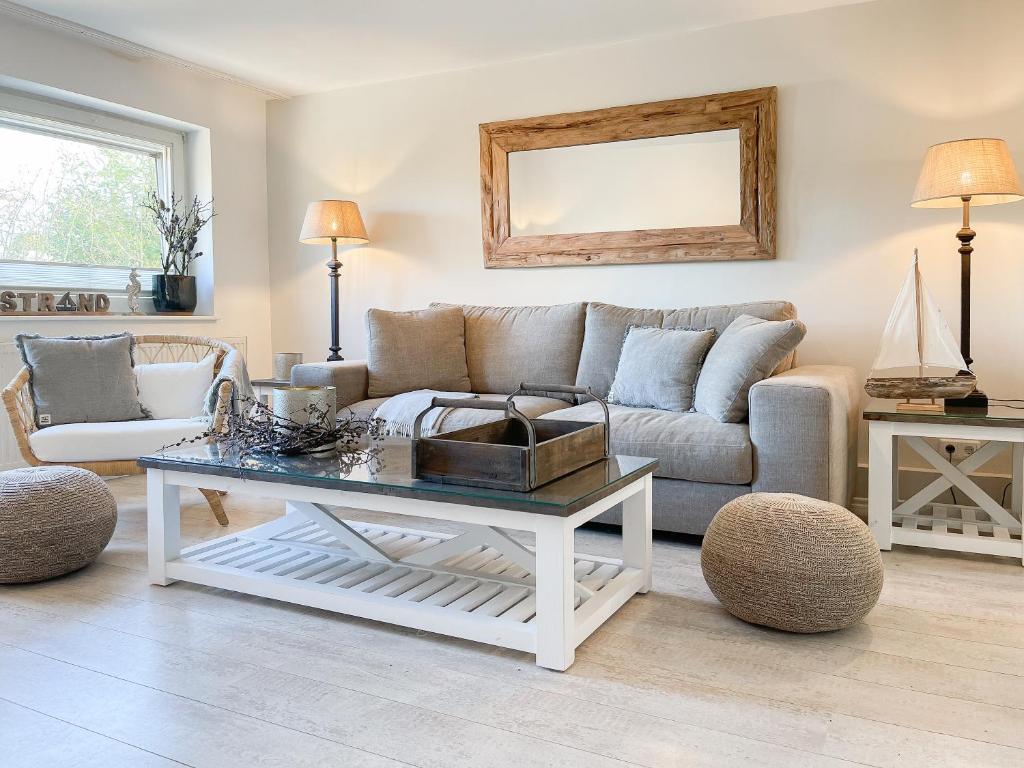 a living room with a couch and a table at Strandbude in Timmendorfer Strand