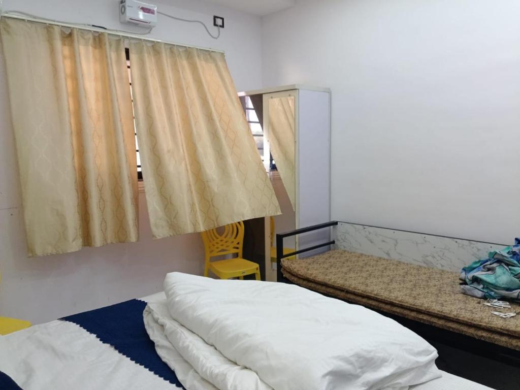 a room with two beds and a window at Mangaldeep Resort and Garden in Bābai