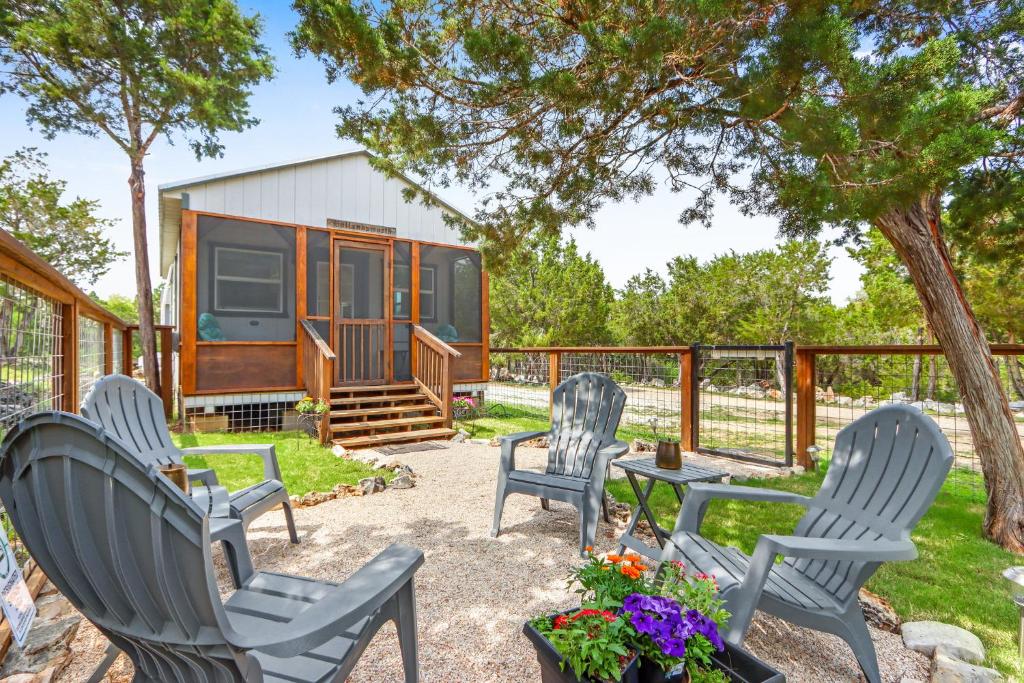 a group of chairs and a table in front of a tiny house at Tiny House on the Hill in New Braunfels