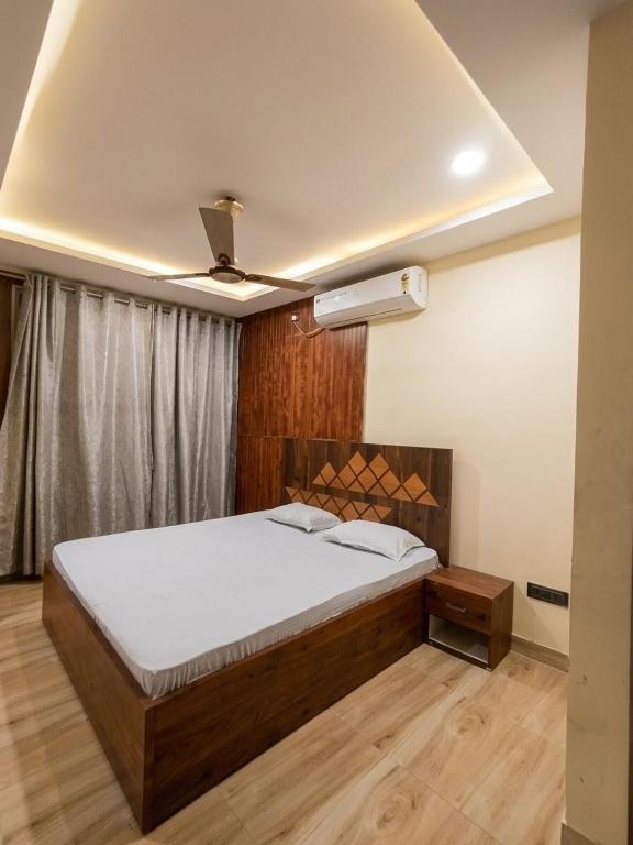 a bedroom with a bed and a ceiling fan at M D Guest House in Guwahati