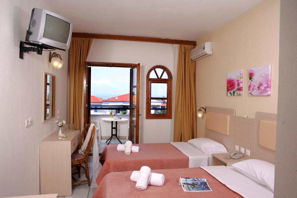 Postel nebo postele na pokoji v ubytování Hotel Calypso