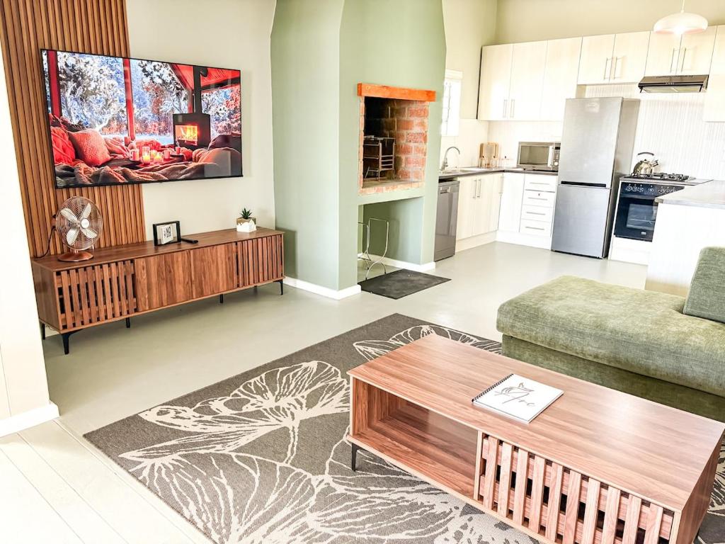 a living room with a couch and a table at Arc On Ray 31 in Britannia Bay