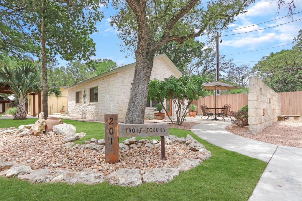 a house with a sign in the front yard at Three Sisters - Casita 1 in Wimberley