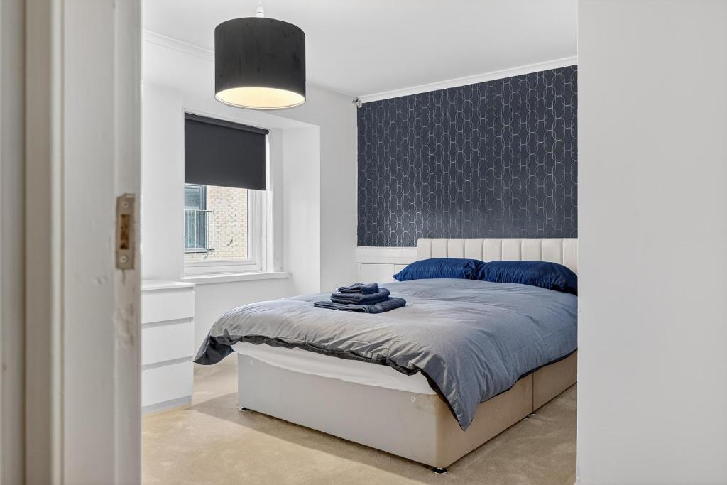 a bedroom with a bed with a black headboard at Seaside Snug in Largs