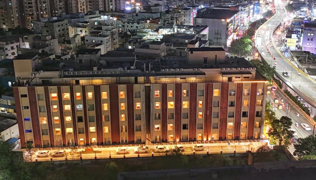 a large building in a city at night at The Altruist Hitech Hotel in Hyderabad