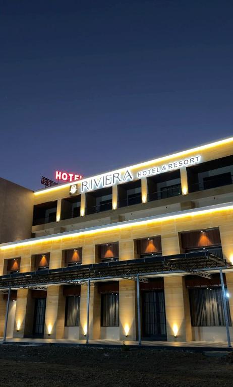 a hotel building with a sign on top of it at Riviera Hotel and Resort in Choli