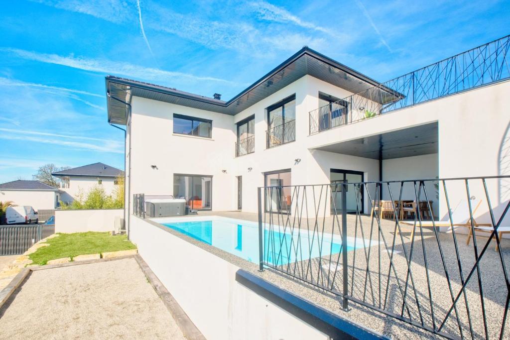 a house with a swimming pool in front of it at BELLEVUE 1, piscine, jacuzzi, sauna in Champcevinel